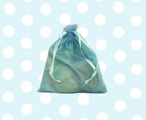 blue organza bag against a spotty blue background